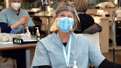 Friendly nurse ready to administer vaccines