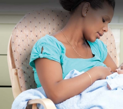 New mom breastfeeding newborn.
