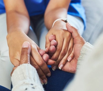 Nurse holding patient's hands