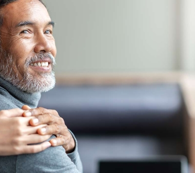 middle age man with comforting caregiver hand on shoulder