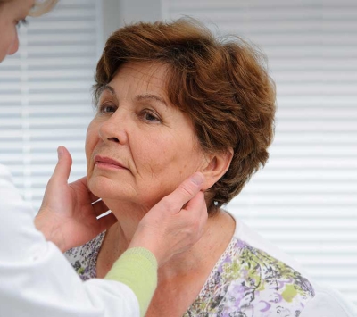 doctor diagnosing woman with head and neck condition