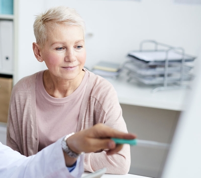 Mature female patient consulting doctor