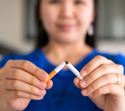 Woman breaking a cigarette 