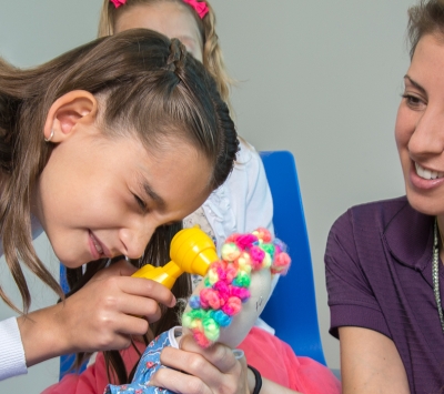 child learns sibling care with adult