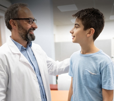 Doctor greeting teenage boy