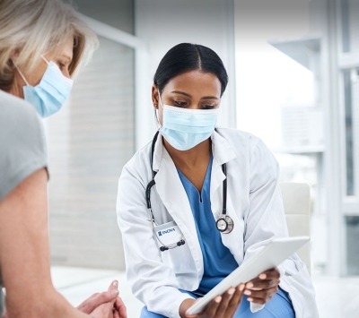 Senior patient and doctor viewing tablet