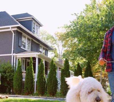 Man walking his dog in neighborhood