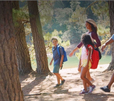 Family of four hiking by a lake