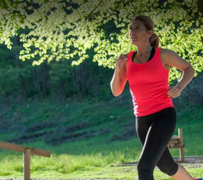 middle aged woman jogging outdoors