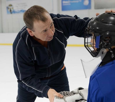 Coach evaluating youth hockey player