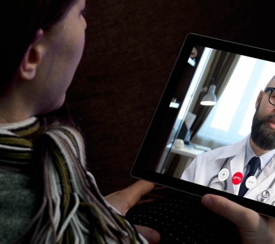 Female patient talking with doctor on laptop screen 