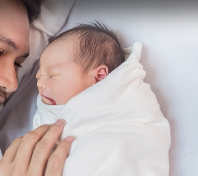 Diverse newborn and father