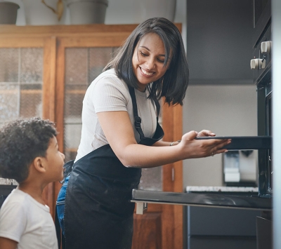 Diverse mom cooking with her son