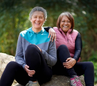 Two mature female friends enjoying outdoors.
