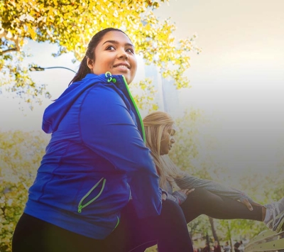 Two female fitness partners outdoors