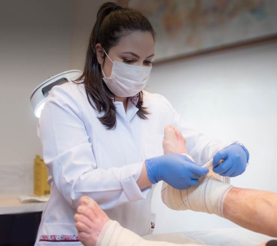 Medical specialist wrapping foot 