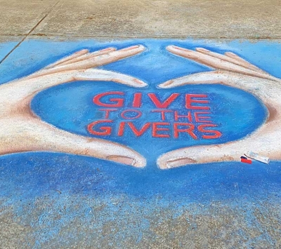 Chalk drawing of hand heart with Give to Givers written.