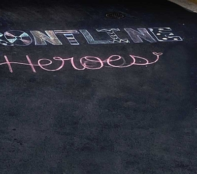 A chalk drawing that says "Frontline Heroes"
