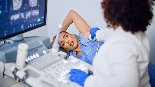 Medical tech examining female patient