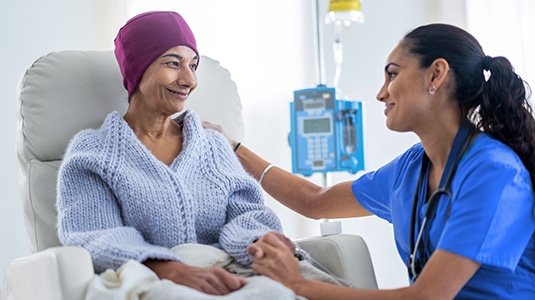 Female cancer patient greeted by nurse