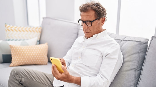 mature man using smartphone