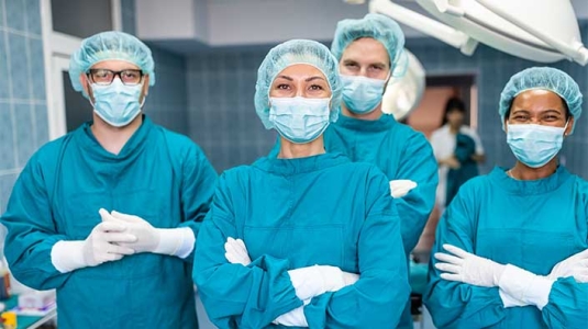 group shot of doctors in scrubs and PPE