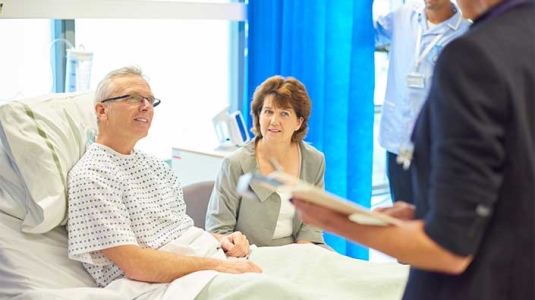 doctor and technician talking to patient and caregiver