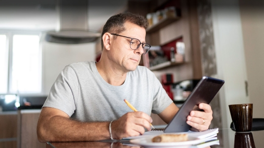 Middle aged man researching information about thoracic oncology