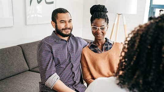 Diverse couple conversation with doctor 