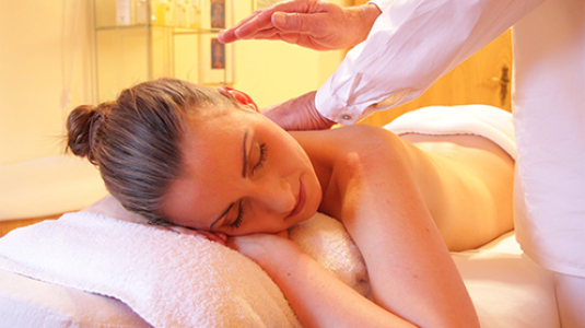 masseuse hands on woman's back
