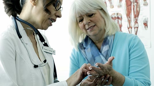 Doctor examining patient hand