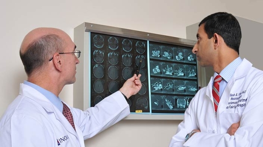 Two neurosurgeons evaluate scans