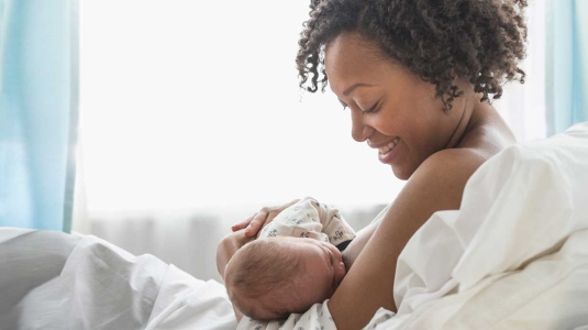 Woman breastfeeding newborn