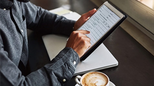 Close up of man typing on tablet