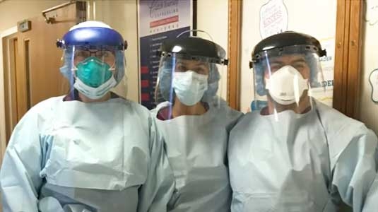 Healthcare team members in protective gear