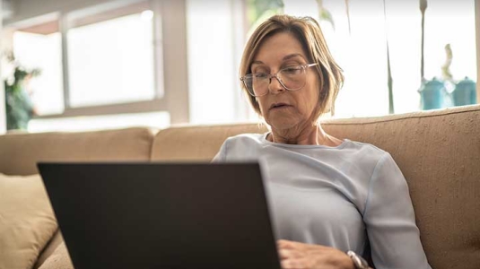 Mature woman on laptop at home
