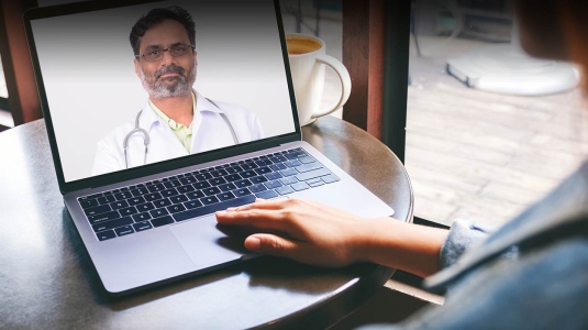 Virtual doctor visit on laptop from home