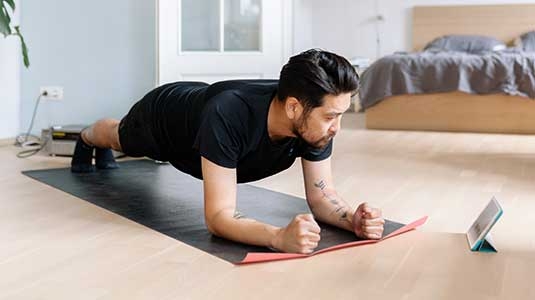 Man stretching at home