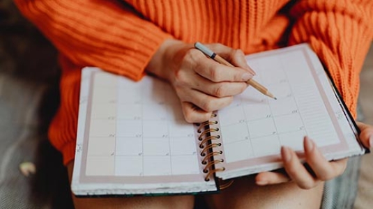 woman writing in notebook