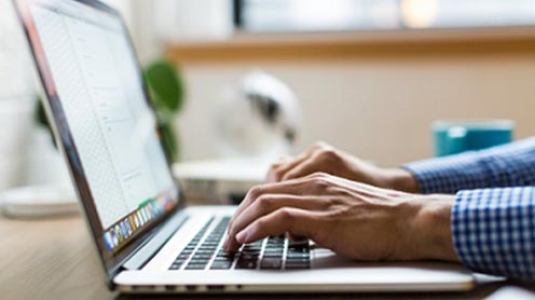 person typing at a laptop