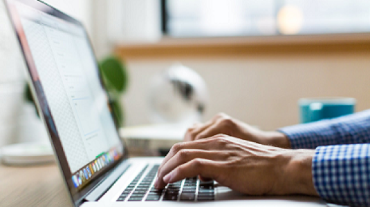 hands typing on keyboard