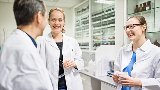 three doctors discussing in lab