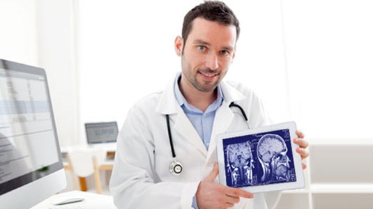 young doctor holding a brain scan image