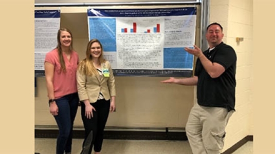 Nurse residents with their presentation poster