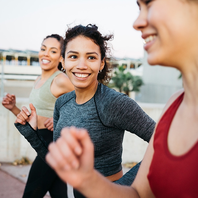 Three females exercising outdoors