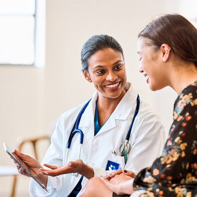 Female doctor reviewing tablet with patient